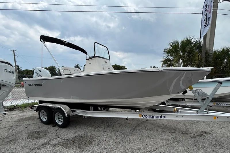 Slide: The Image of 2026 Sea Born LX21 Center Console boat on trailer, parked outdoors. - 52
