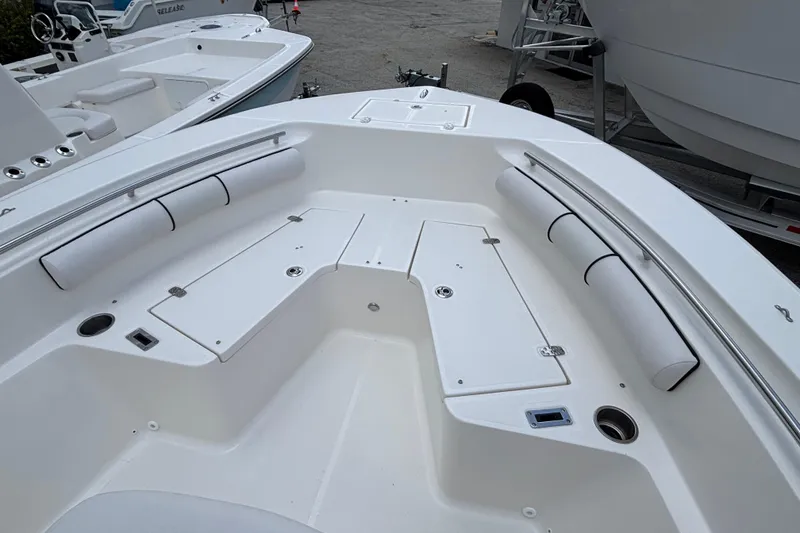Slide: The Image of 2026 Sea Born LX21 Center Console boat interior with cushioned seating and storage compartments. - 7