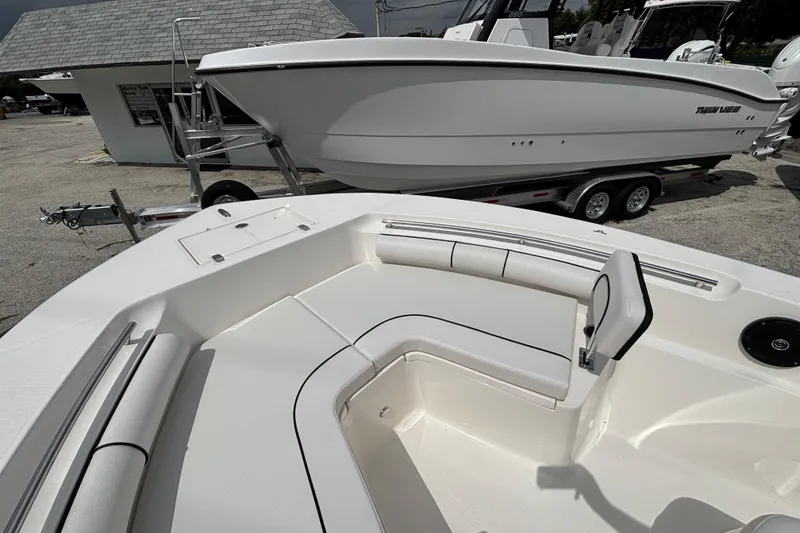 Slide: The Image of 2026 Sea Born LX21 Center Console boat interior with seating, parked on a trailer. - 9