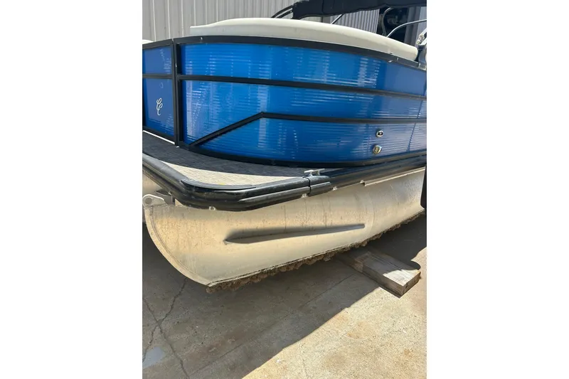 Slide: The Image of 2020 Cypress Cay Seabreeze 232 pontoon boat with blue exterior, docked on concrete. - 0