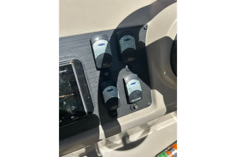 Slide: The Image of Control panel of 2020 Cypress Cay Seabreeze 232 boat with switches and display. - 13