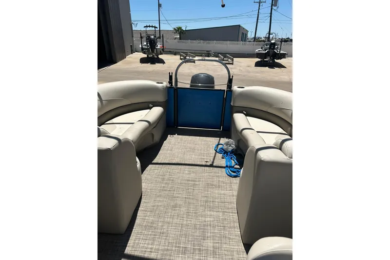 Slide: The Image of 2020 Cypress Cay Seabreeze 232 pontoon boat interior with beige seating and blue accents. - 18