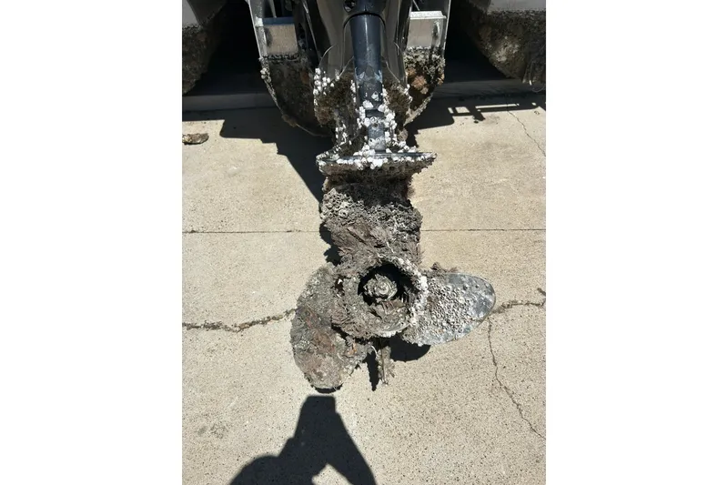 Slide: The Image of Barnacle-covered propeller of a 2020 Cypress Cay Seabreeze 232 boat on concrete. - 3