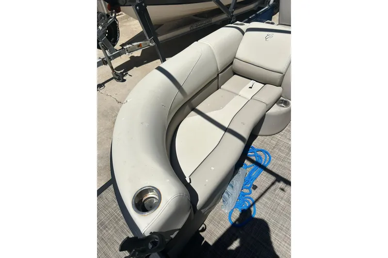 Slide: The Image of 2020 Cypress Cay Seabreeze 232 boat interior with beige seating and cup holders. - 6