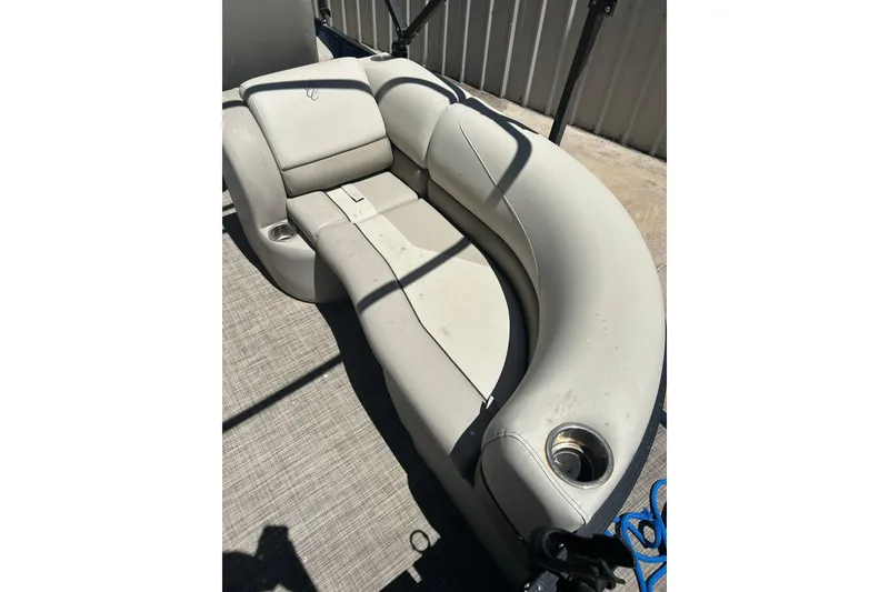 Slide: The Image of 2020 Cypress Cay Seabreeze 232 boat interior with curved seating and cup holders. - 7