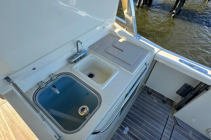Slide: The Image of 2018 Chris-Craft Calypso 30 boat sink and prep area with water view. - 12