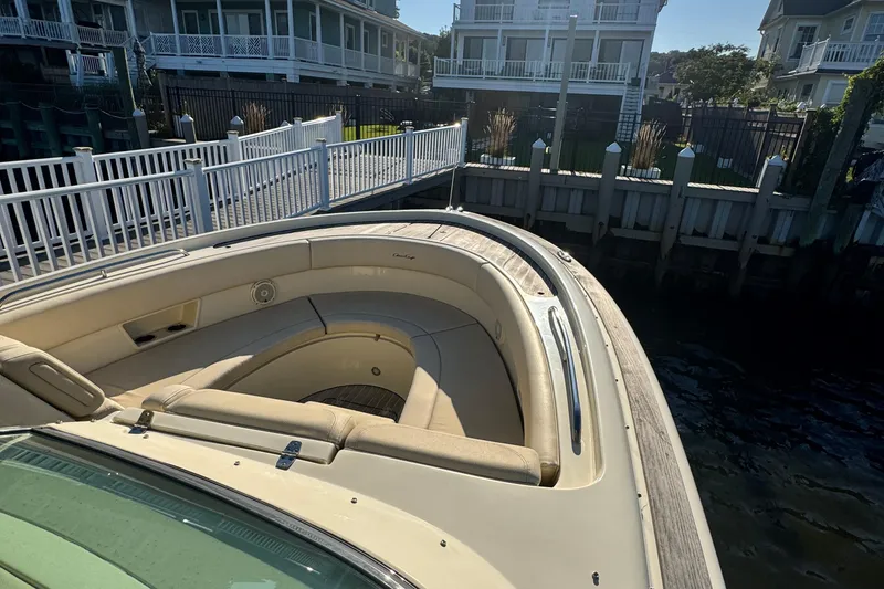 Slide: The Image of 2018 Chris-Craft Calypso 30 boat docked near waterfront homes. - 15