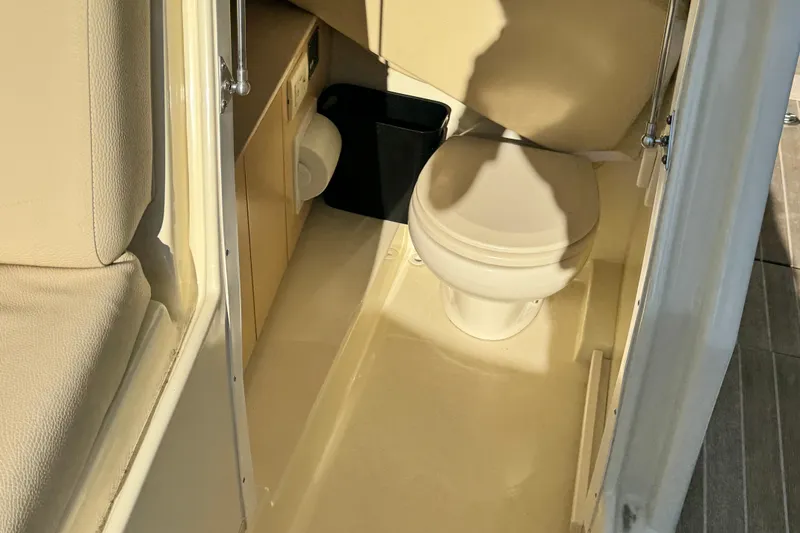 Slide: The Image of 2018 Chris-Craft Calypso 30 boat interior with compact bathroom and toilet. - 17