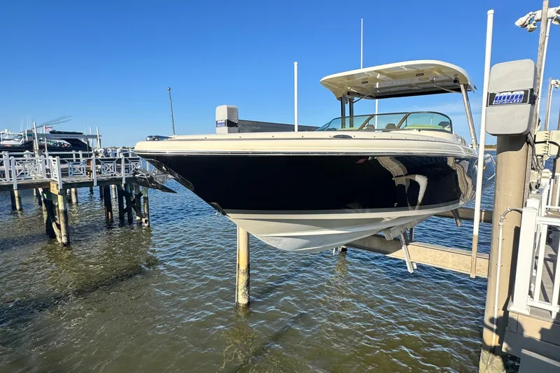 Slide: The Image of 2018 Chris-Craft Calypso 30 with twin Yamaha 300 engines docked at marina. - 2
