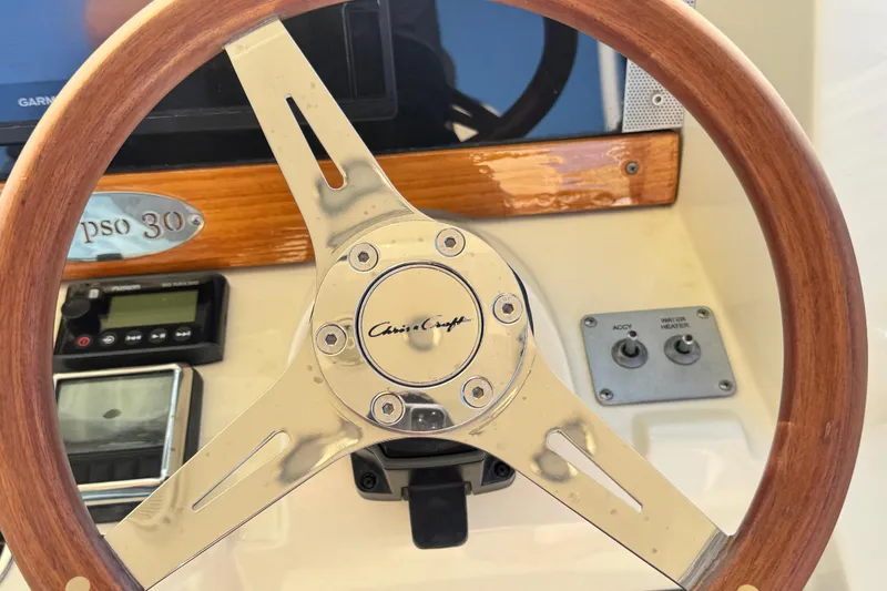 Slide: The Image of 2018 Chris-Craft Calypso 30 steering wheel and dashboard controls. - 8