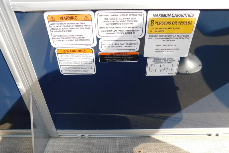 Slide: The Image of Warning labels and capacity information on a 2025 Sun Tracker Bass Buggy boat. - 11