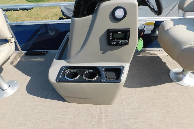 Slide: The Image of Control console of 2025 Sun Tracker Bass Buggy boat with cup holders and stereo system. - 12