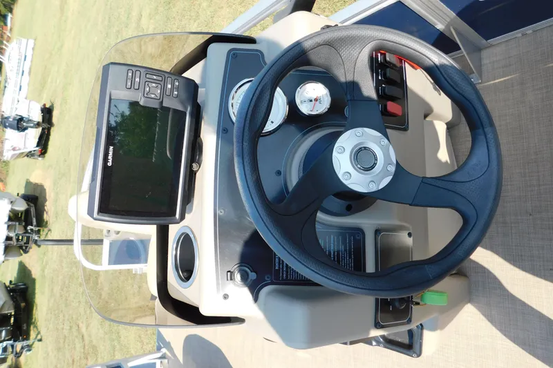 Slide: The Image of Steering console of 2025 Sun Tracker Bass Buggy with Garmin display and gauges. - 13