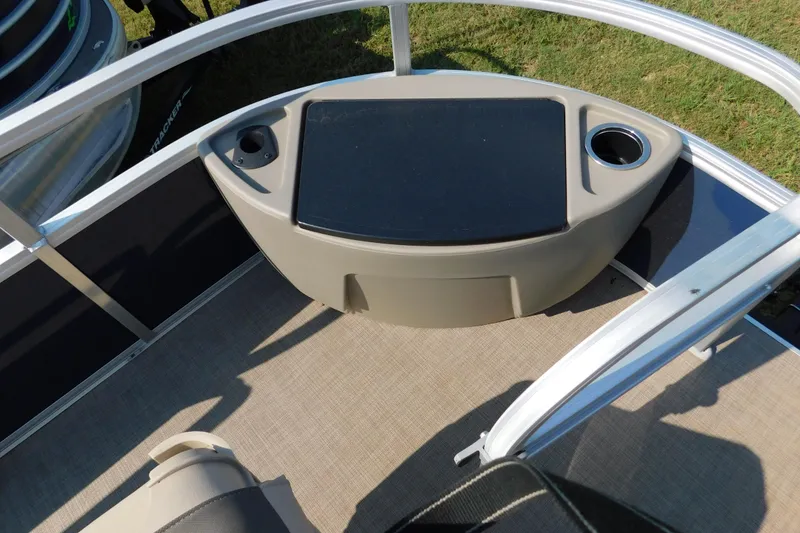 Slide: The Image of 2025 Sun Tracker Bass Buggy boat interior with cup holders and storage compartment. - 5