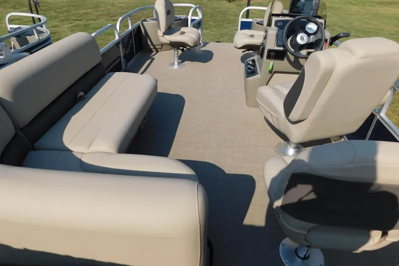 Slide: The Image of 2025 Sun Tracker Bass Buggy interior with beige seating and steering console. - 9