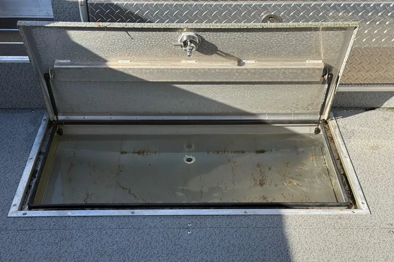 Slide: The Image of Open storage compartment on 2025 Thunder Jet 24 Alexis Pro boat. - 10