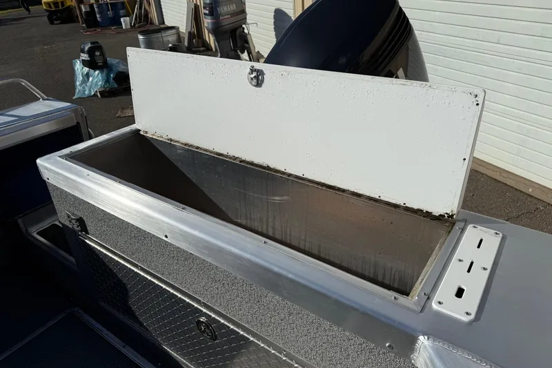 Slide: The Image of Open storage compartment on 2025 Thunder Jet 24 Alexis Pro boat, showcasing interior space. - 12