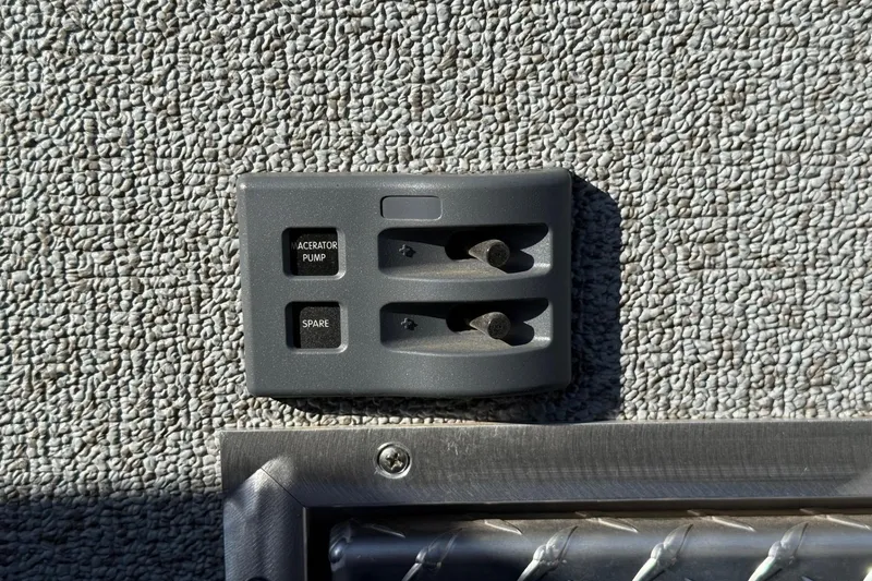 Slide: The Image of Control panel on 2025 Thunder Jet 24 Alexis Pro boat, featuring macerator pump switches. - 14