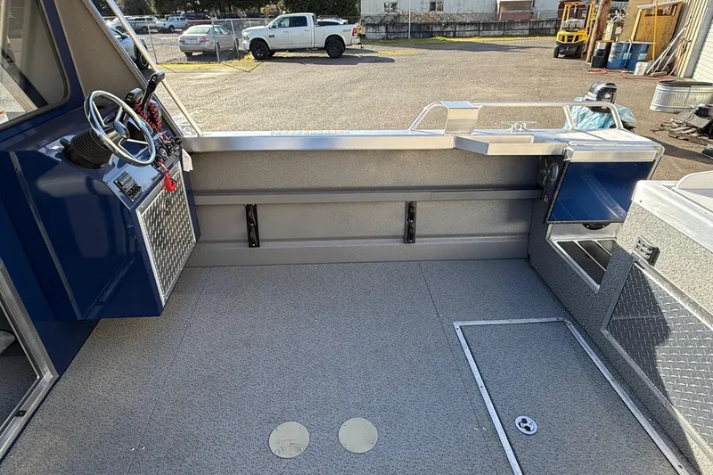Slide: The Image of Interior of 2025 Thunder Jet 24 Alexis Pro boat, featuring steering console and storage compartments. - 15