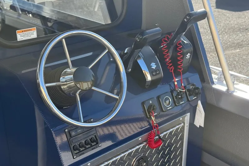 Slide: The Image of Steering console of 2025 Thunder Jet 24 Alexis Pro boat with controls and switches. - 16