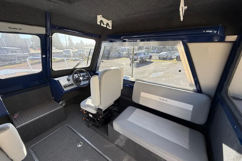 Slide: The Image of Interior of 2025 Thunder Jet 24 Alexis Pro boat, featuring seating and steering console. - 19
