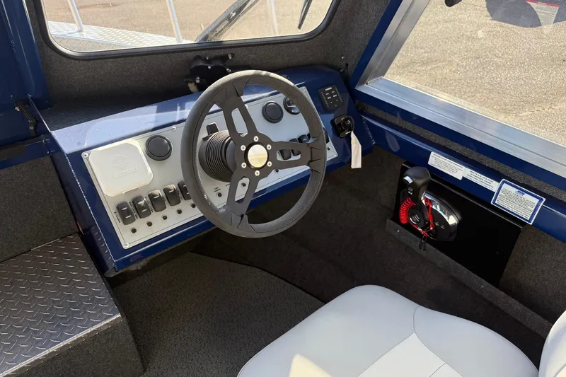 Slide: The Image of Interior view of 2025 Thunder Jet 24 Alexis Pro boat cockpit with steering wheel and controls. - 22