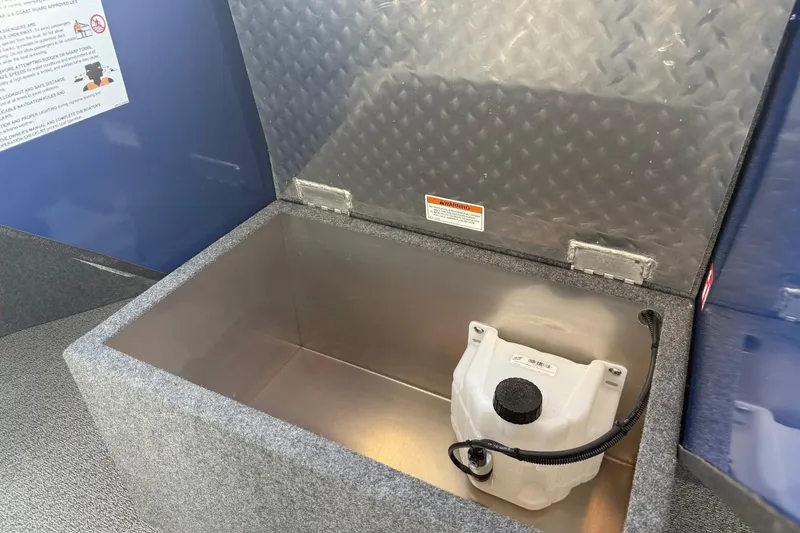 Slide: The Image of Storage compartment in 2025 Thunder Jet 24 Alexis Pro boat, featuring a secure container. - 23