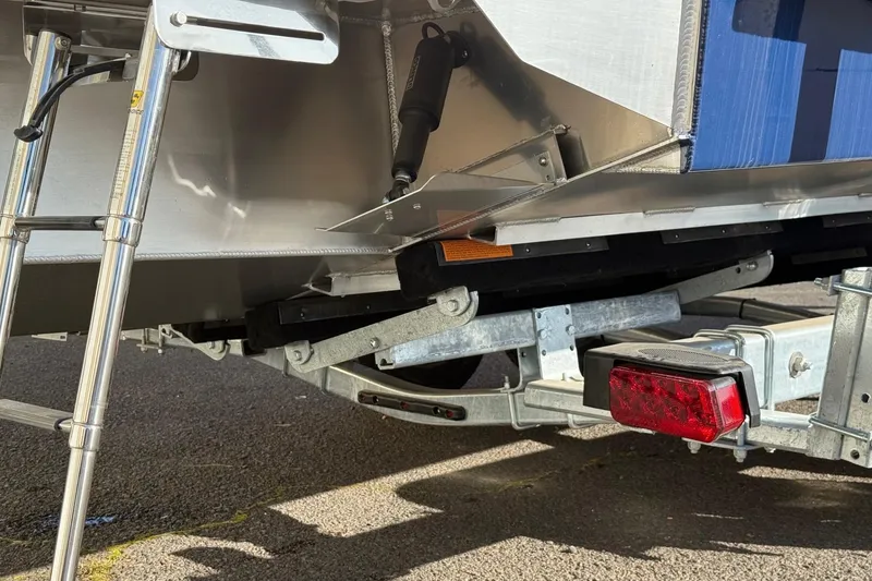 Slide: The Image of Trailer and rear view of 2025 Thunder Jet 24 Alexis Pro boat. - 28