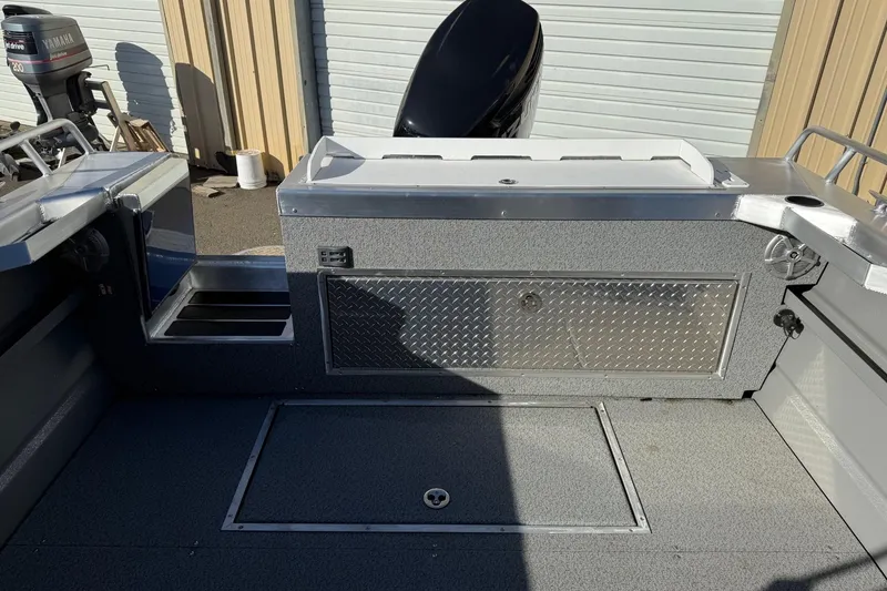 Slide: The Image of 2025 Thunder Jet 24 Alexis Pro boat interior with storage compartments and Yamaha outboard motor. - 9