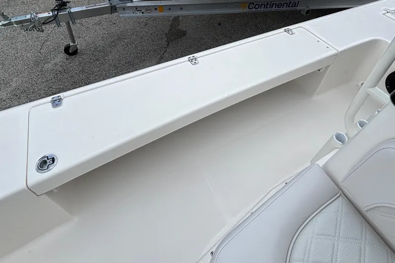 Slide: The Image of 2026 Spyder FX19 Vapor boat interior with white seating and storage compartment. - 13