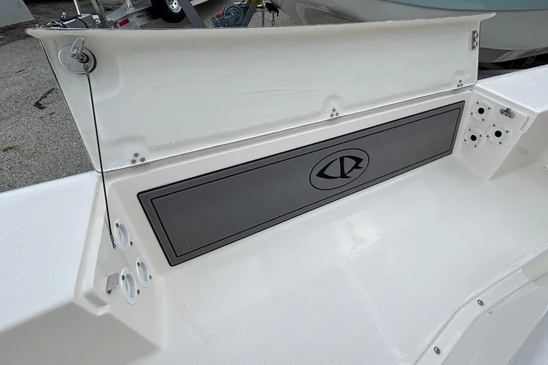 Slide: The Image of 2026 Spyder FX19 Vapor boat interior with storage compartment and rod holders. - 14