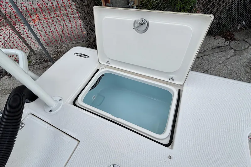 Slide: The Image of Open storage compartment on 2026 Spyder FX19 Vapor boat, showcasing interior design. - 17