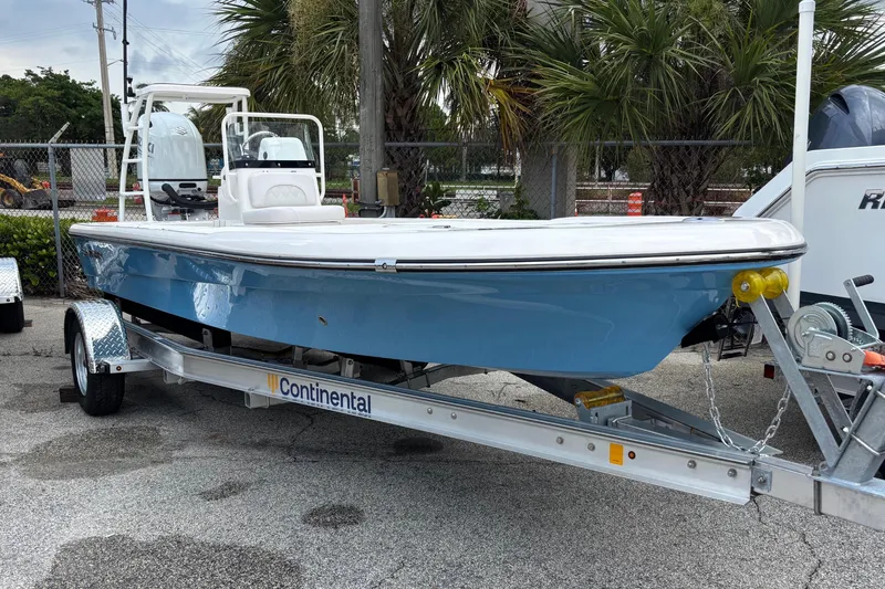 Slide: The Image of 2026 Spyder FX19 Vapor boat on Continental trailer, parked outdoors. - 2