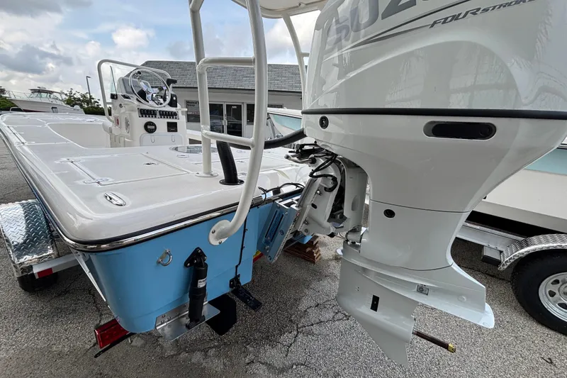 Slide: The Image of 2026 Spyder FX19 Vapor boat with powerful outboard motor, parked on a trailer. - 5