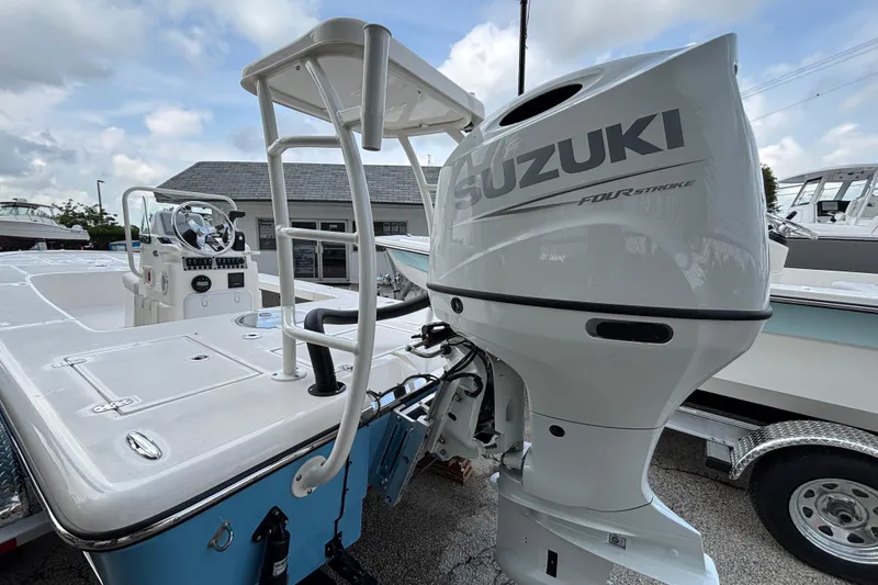 Slide: The Image of 2026 Spyder FX19 Vapor boat with Suzuki four-stroke engine, docked outdoors. - 6