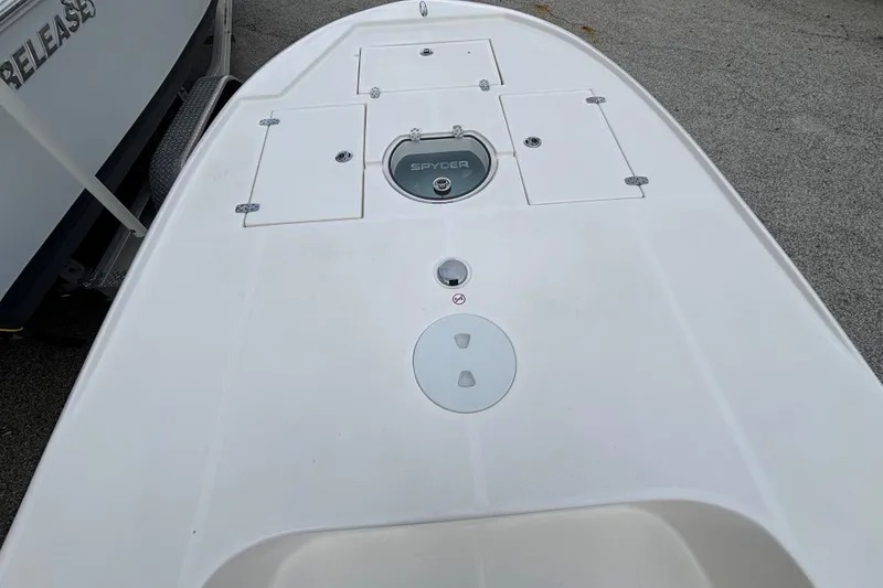 Slide: The Image of 2026 Spyder FX19 Vapor boat deck with storage compartments and logo. - 9