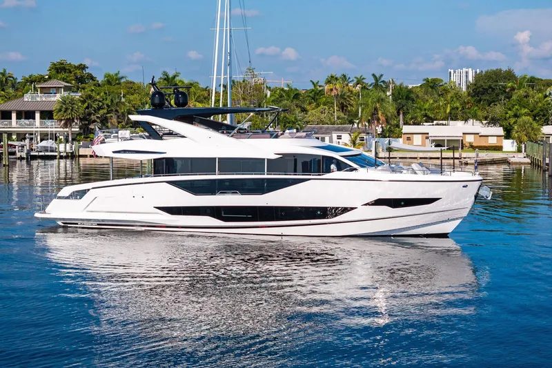 The Image of 2024 Sunseeker 90 Ocean yacht cruising on a serene waterway. - 0