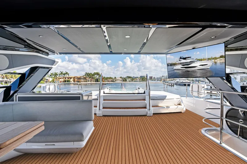 Slide: The Image of Luxurious 2024 Sunseeker 90 Ocean yacht deck with modern seating and scenic marina view. - 21