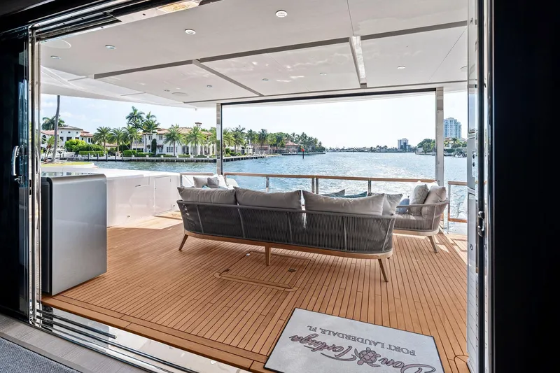 Slide: The Image of Luxurious 2024 Sunseeker 90 Ocean yacht deck with waterfront view and elegant seating. - 32