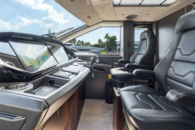 Slide: The Image of 2024 Sunseeker 90 Ocean yacht cockpit with modern controls and luxurious leather seating. - 38