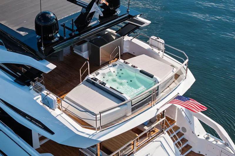 Slide: The Image of 2024 Sunseeker 90 Ocean yacht with jacuzzi and American flag on deck. - 4