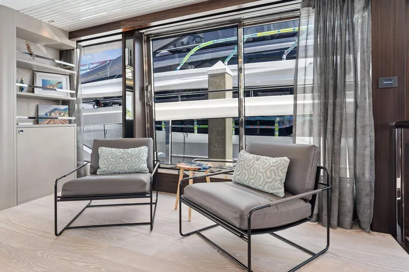 Slide: The Image of Luxurious interior of 2024 Sunseeker 90 Ocean yacht with modern seating and large windows. - 43