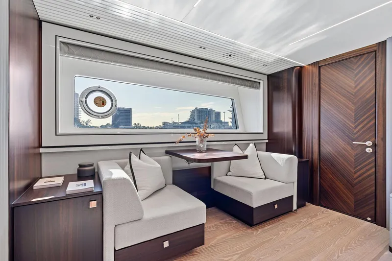 Slide: The Image of Luxurious interior of 2024 Sunseeker 90 Ocean yacht with elegant seating and large window view. - 50