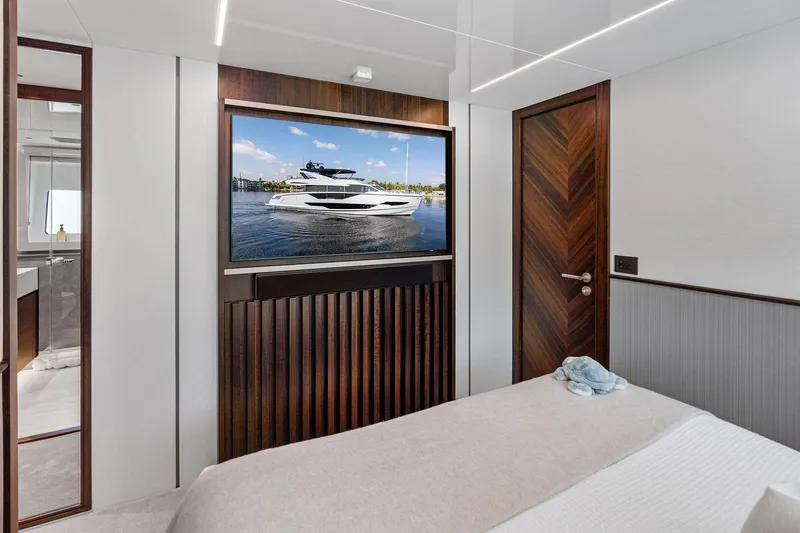 Slide: The Image of Luxurious interior of 2024 Sunseeker 90 Ocean yacht with elegant wood accents. - 55