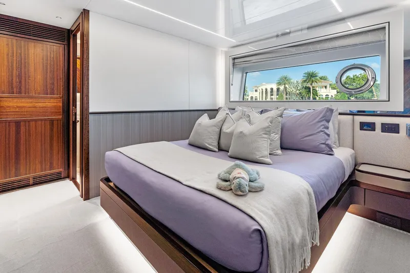 Slide: The Image of Luxurious bedroom interior of 2024 Sunseeker 90 Ocean yacht with elegant decor and scenic window view. - 59