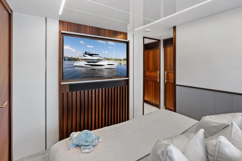 Slide: The Image of Luxurious 2024 Sunseeker 90 Ocean yacht interior with elegant wood finishes and plush bedding. - 61