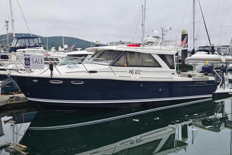 The Image of 2020 Cutwater C-32 C boat docked, for sale, in a marina setting. - 0