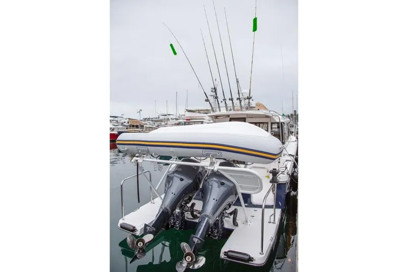 Slide: The Image of Manufacturer Provided Image: 2020 Cutwater C-32 C boat with dual outboard motors and fishing rods. - 12
