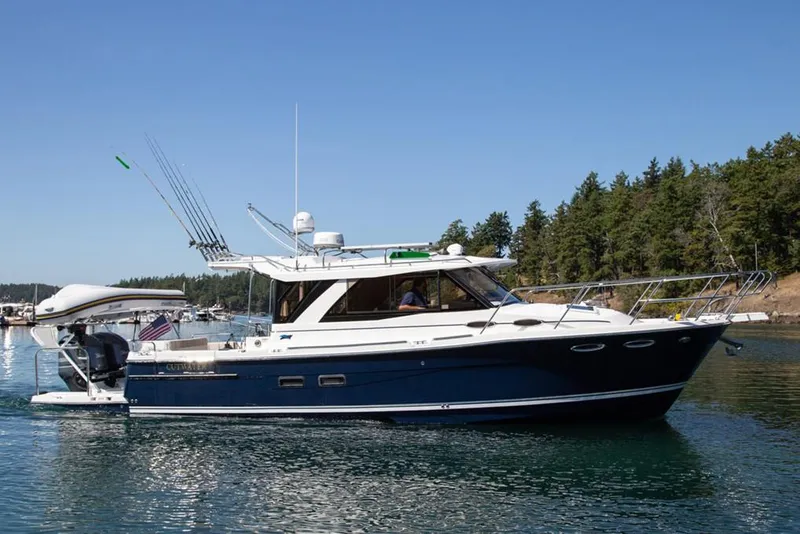 Slide: The Image of Manufacturer Provided Image: 2020 Cutwater C-32 C boat cruising on a calm lake with forested shoreline. - 4