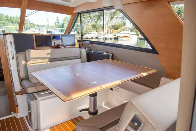 Slide: The Image of Manufacturer Provided Image: Interior of 2020 Cutwater C-32 C boat with dining table and seating area. - 7